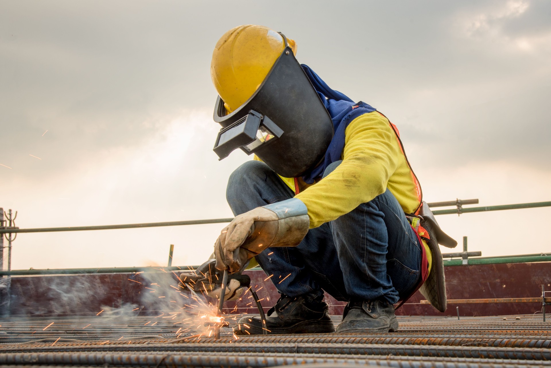 Man welding a metal at a jobsite as a mobile welder